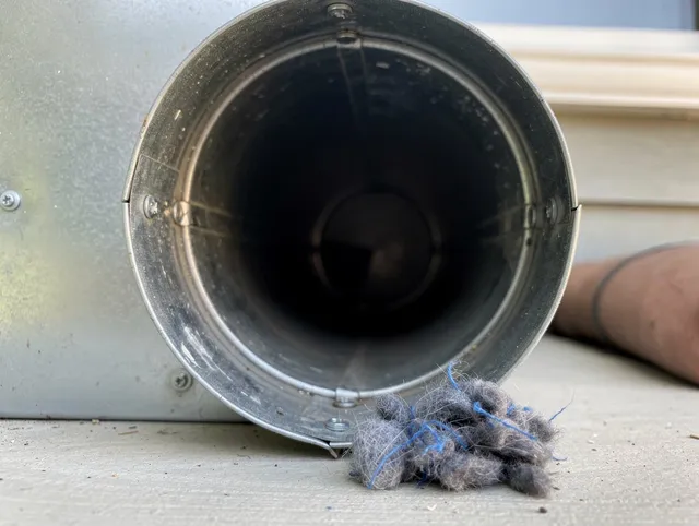Acushnet Dryer Vent Cleaning technician using specialized equipment to clear severe dryer vent blockage in Acushnet